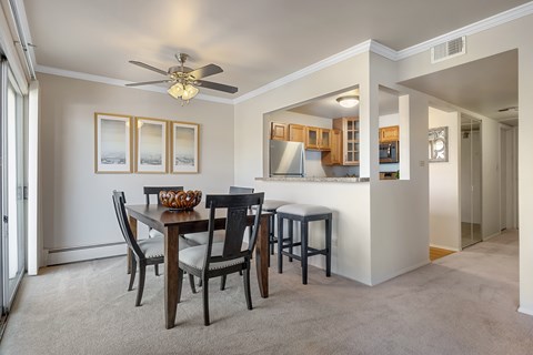 A dining room with a table set for four.