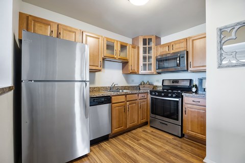 A kitchen with wooden cabinets and stainless steel appliances.