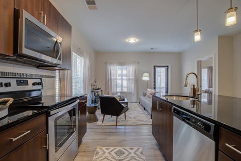 a kitchen with an island and a living room with a couch