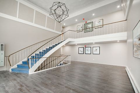 the landing of a staircase in a living room with a blue staircase