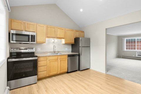 A kitchen with wooden cabinets and stainless steel appliances.