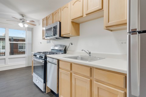 A kitchen with wooden cabinets and a white countertop.