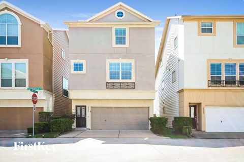 a street view of two buildings with a garage door
