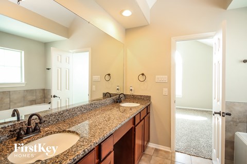 a bathroom with two sinks and a large mirror