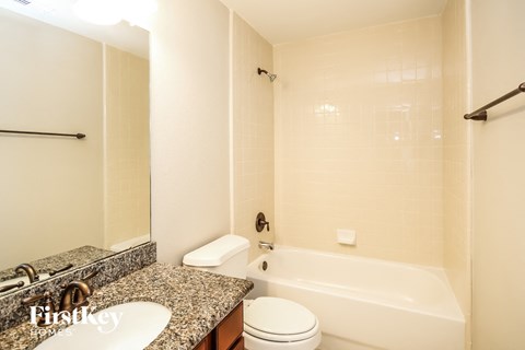 a bathroom with a tub and a sink and a toilet