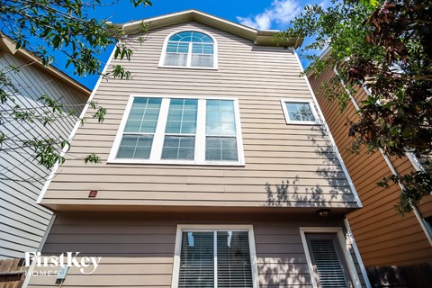 a view of the side of a house with large windows