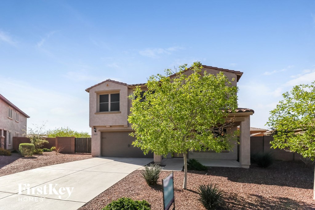 a single story home with a tree in front of it