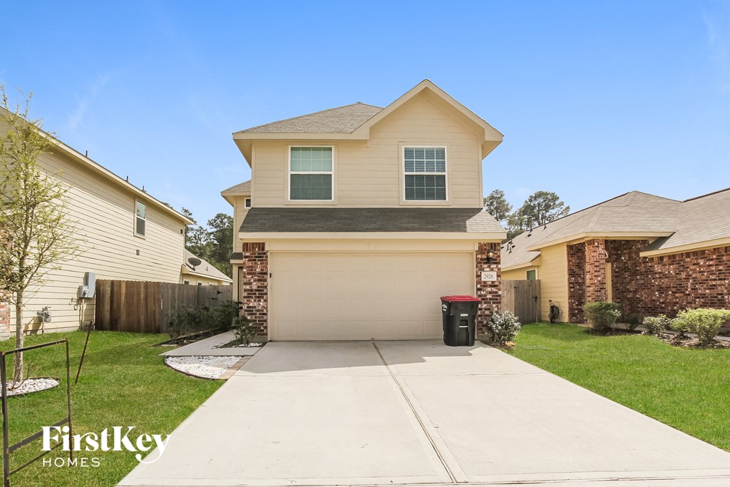 A two-story house with a garage is for sale.
