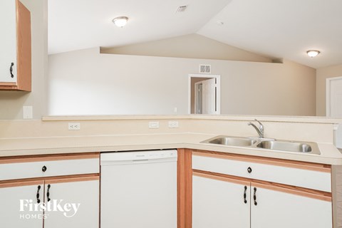 A kitchen with a sink and cabinets.