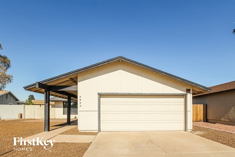 a garage with a white garage door in front of a house
