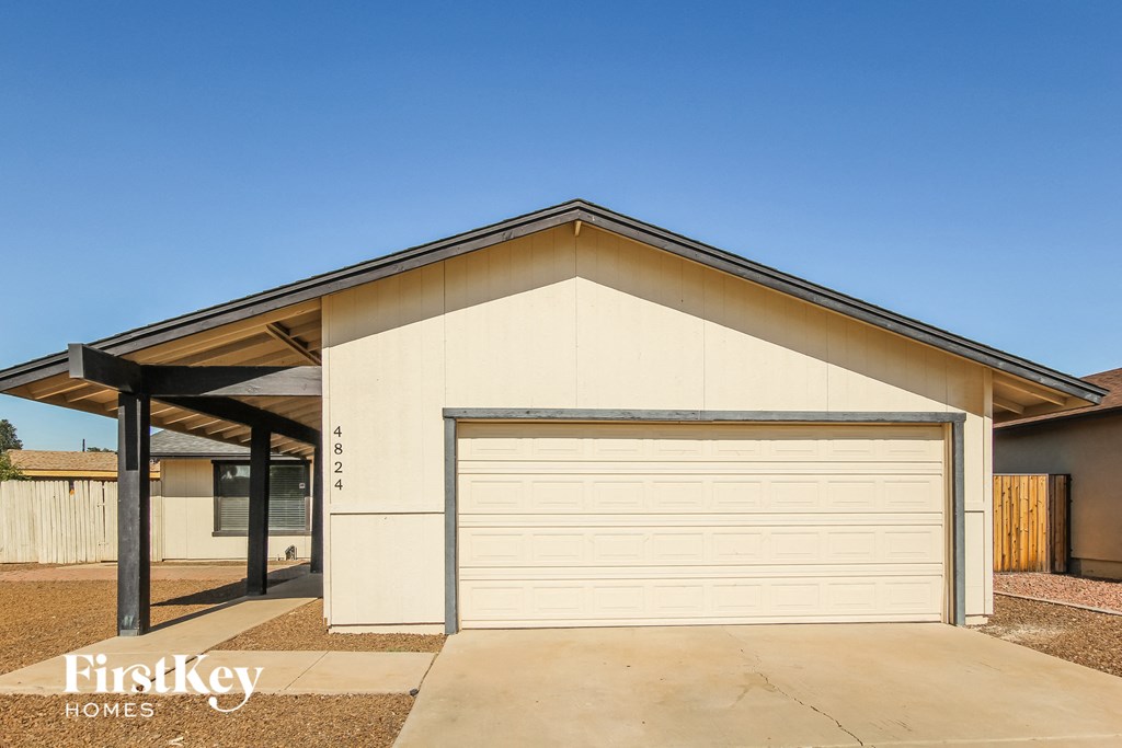 a garage with a white garage door in front of a house