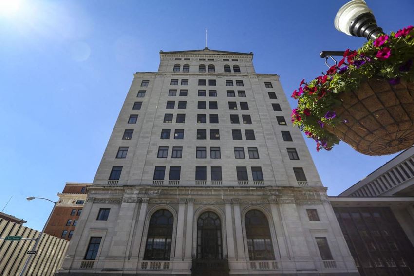 a tall building with a hanging basket of flowers