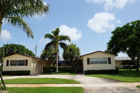 a house with palm trees in front of it