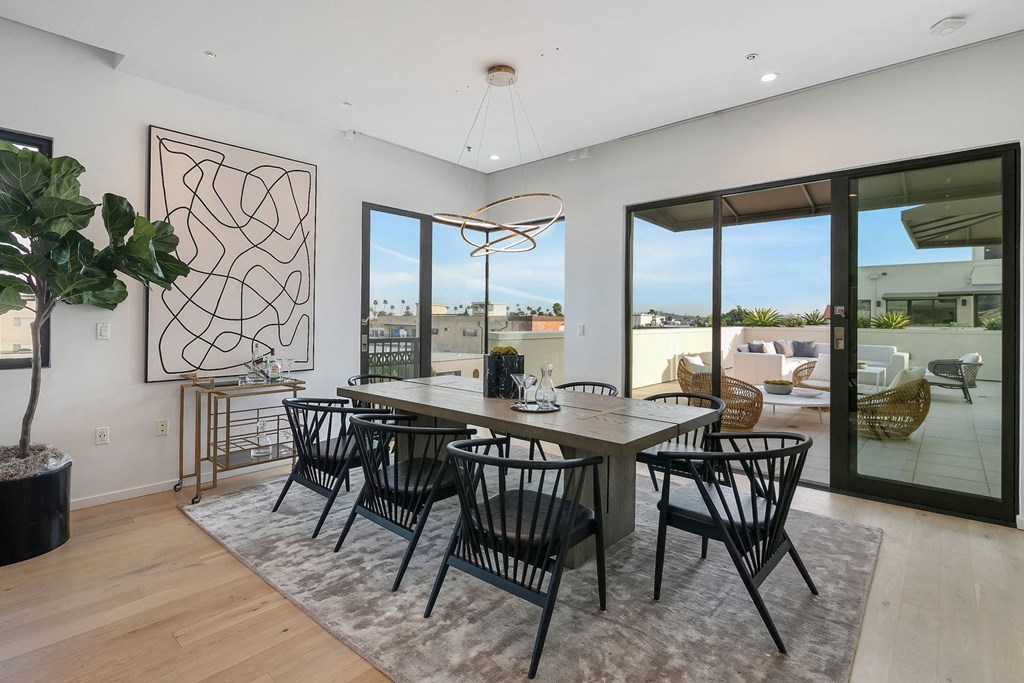 A modern dining room with a large table and chairs.