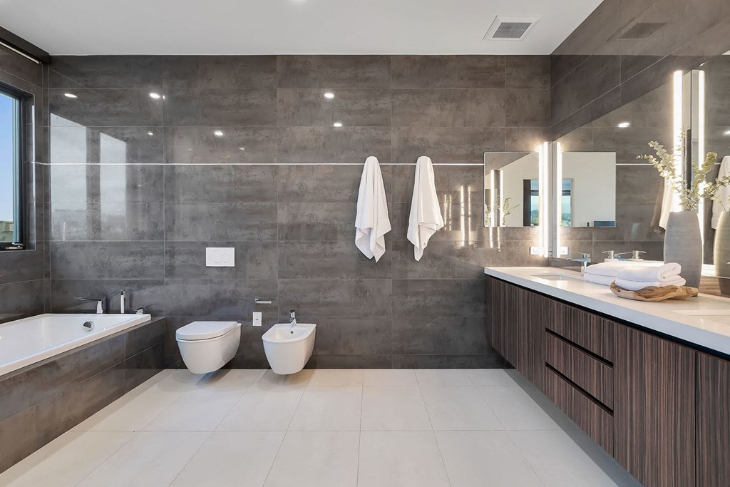 A bathroom with a tub, toilet, and sink.