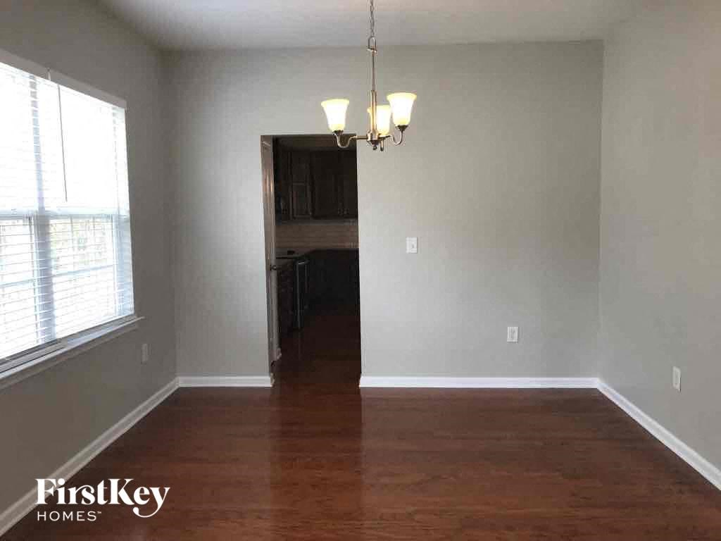 an empty living room with a wood floor and a window