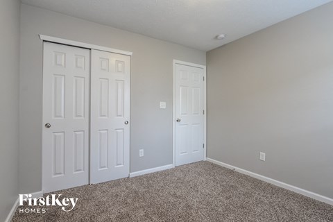 a bedroom with two closets and two doors