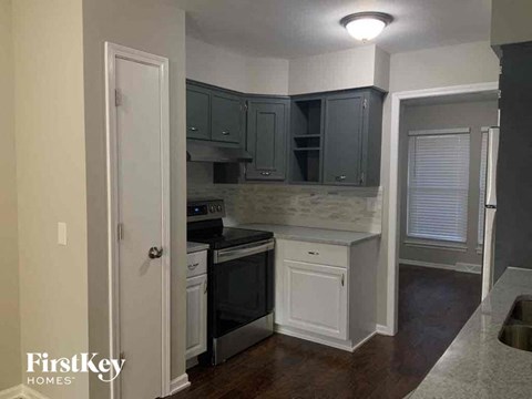 a small kitchen with black appliances and white cabinets