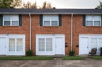 a red brick house with white doors and windows