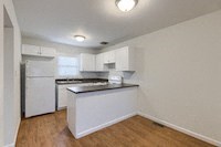an empty kitchen with an island in the middle