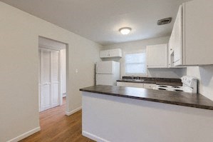 an empty kitchen with a counter top