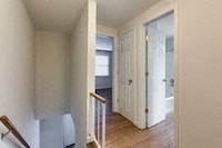 a white room with a staircase and a white door