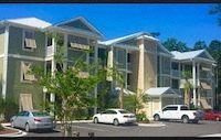 an image of a building with cars parked in front of it