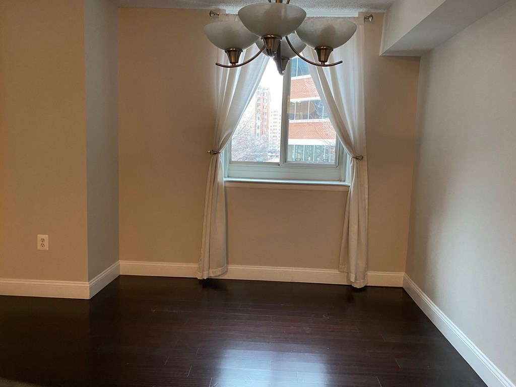 a dining room with a window and a chandelier