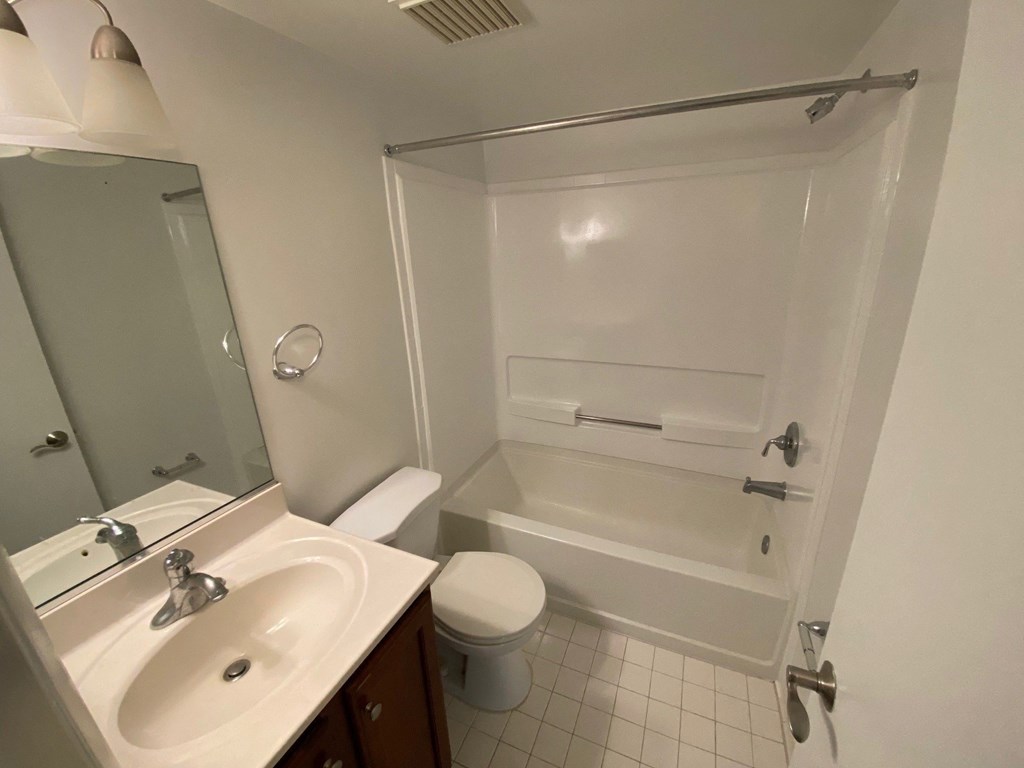 a bathroom with a sink toilet and a bath tub