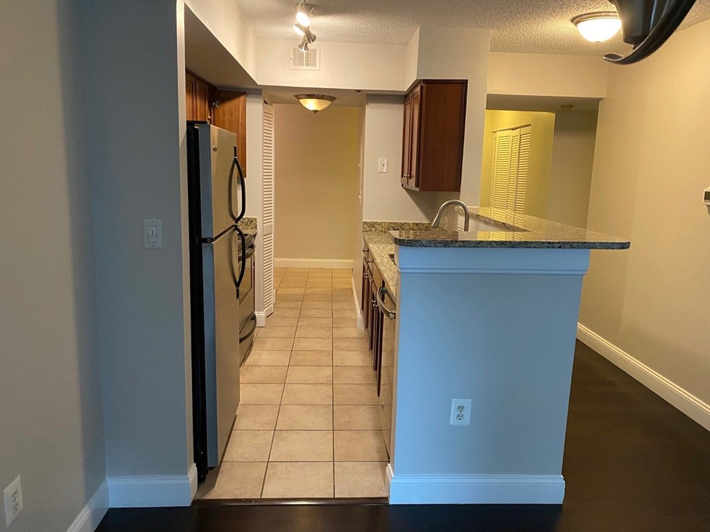 a kitchen with a counter top and a refrigerator