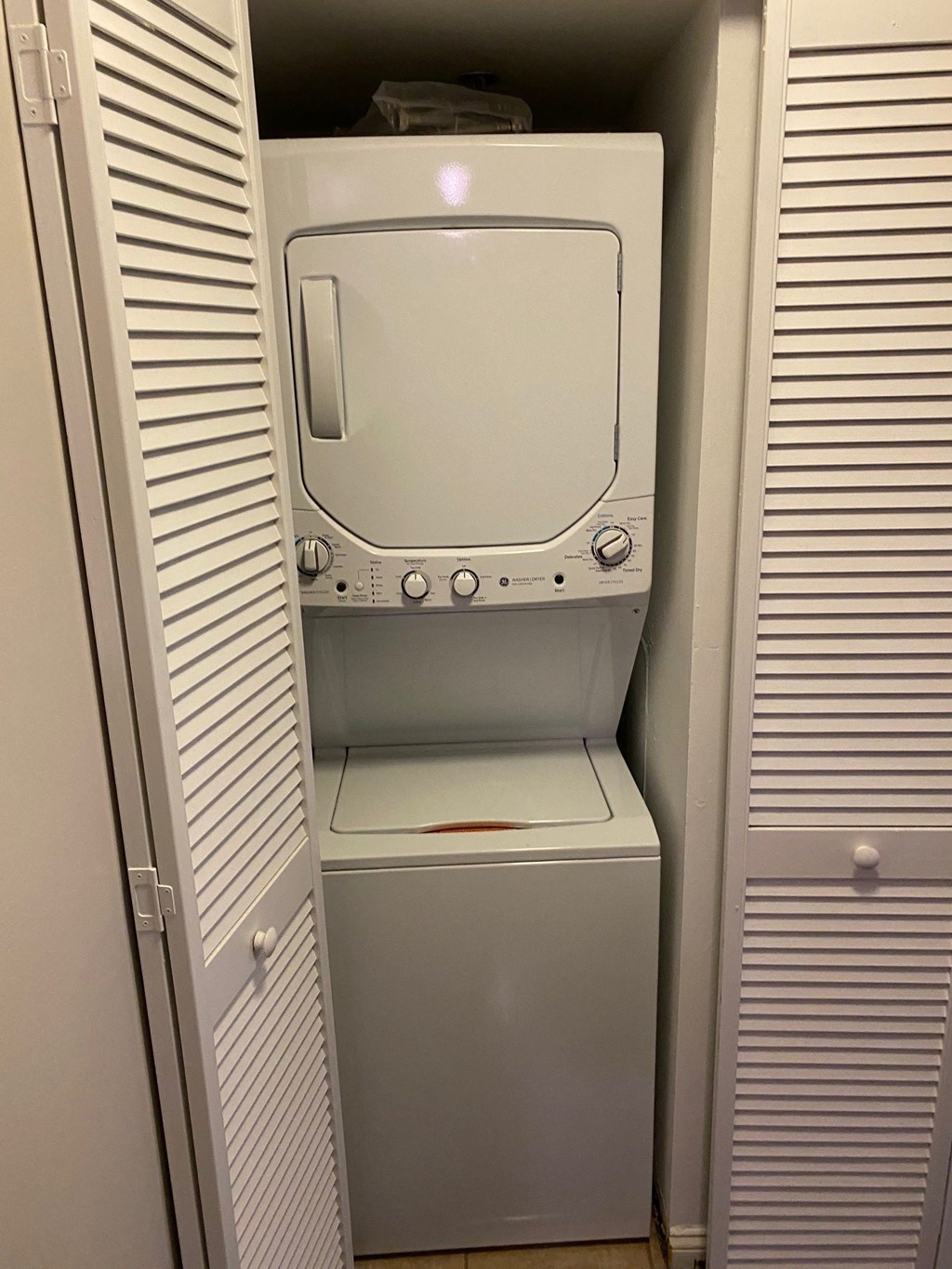 an empty washer and dryer in a closet