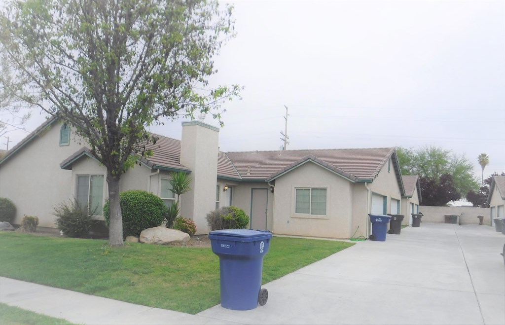 a house with trash cans in front of it