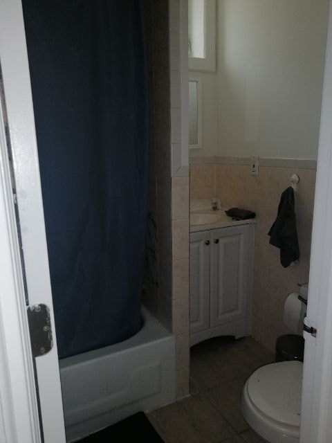 a bathroom with a toilet and a sink and a shower