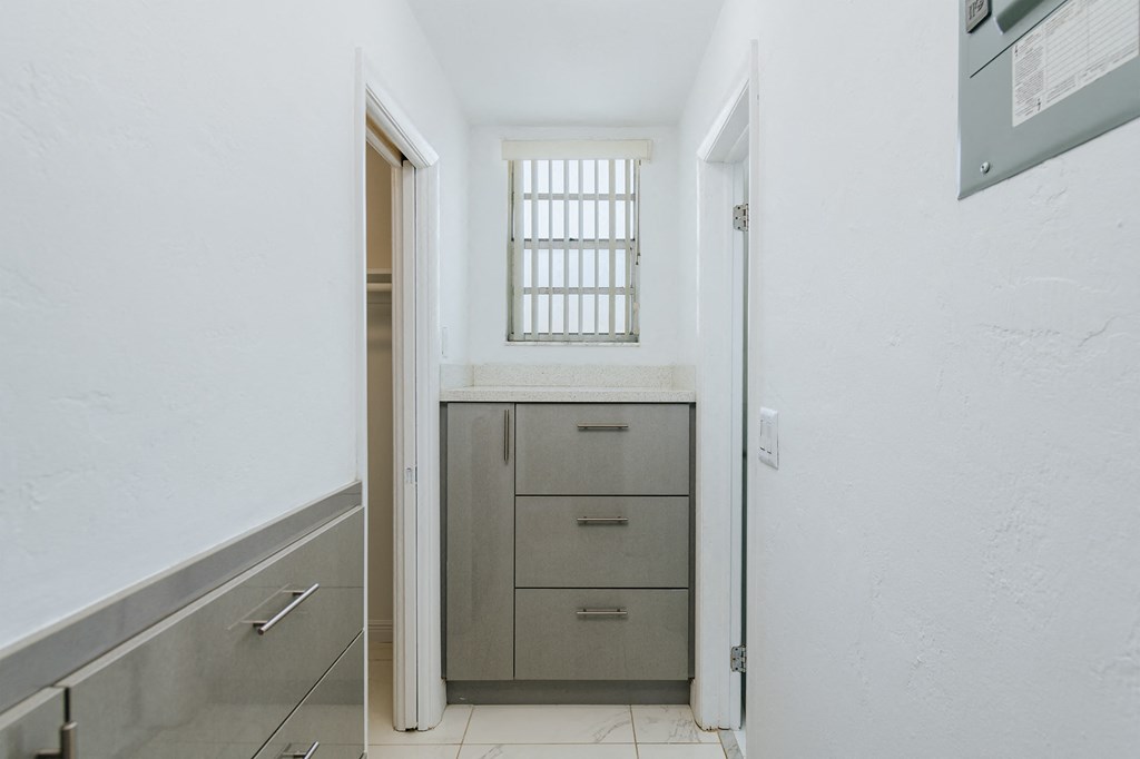 a utility room with a sink and a door to a closet