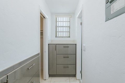 a utility room with a sink and a door to a closet