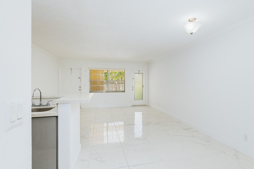 an empty kitchen with a sink and a counter