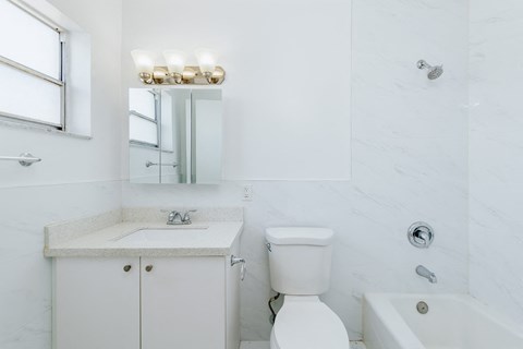 a bathroom with a sink toilet and a mirror