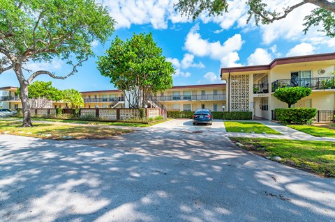 a car parked in front of an apartment building