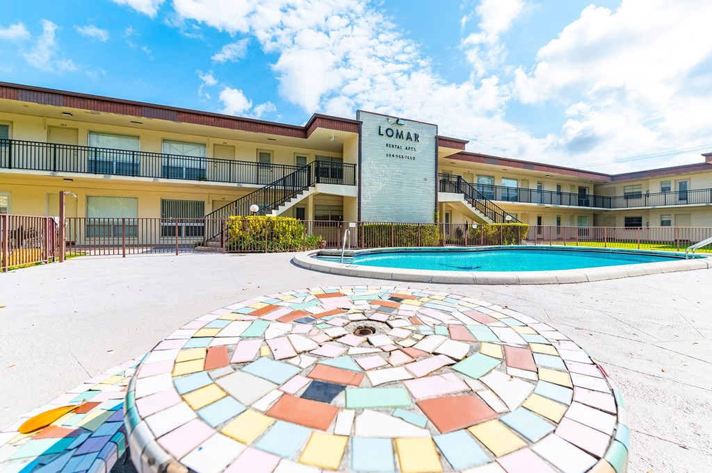 a building with a pool and a mosaic in front of it