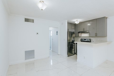 a kitchen with a counter and a refrigerator and a sink
