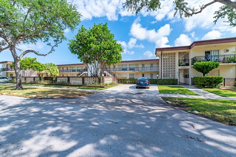 a car parked in front of an apartment building