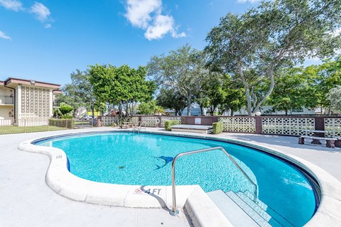 a swimming pool with stairs next to a resort style pool