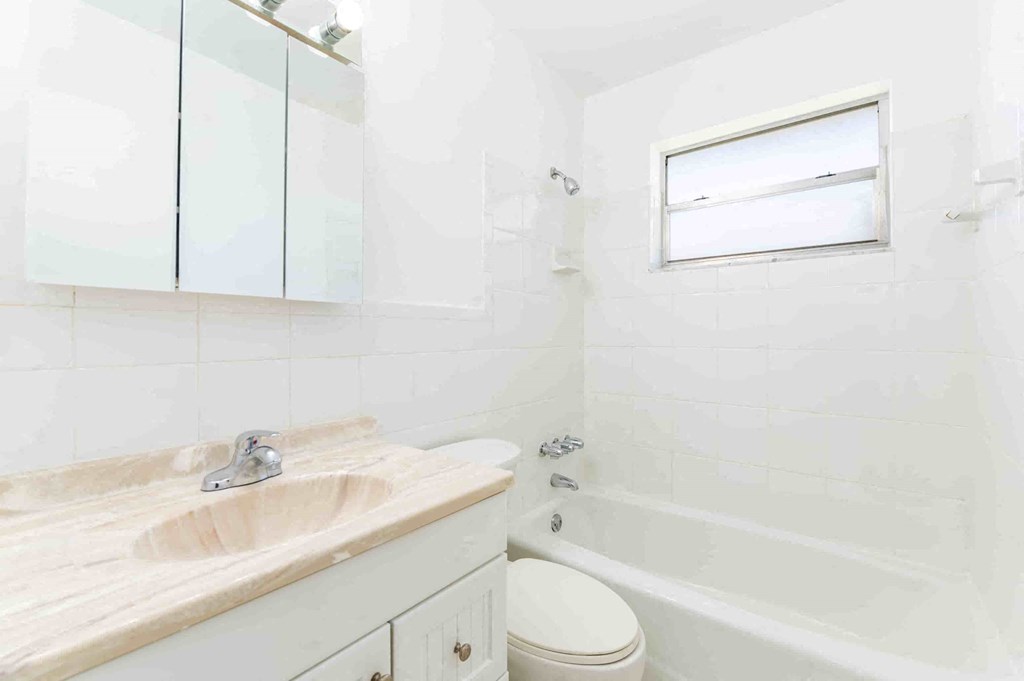 a bathroom with a sink and a tub and a toilet