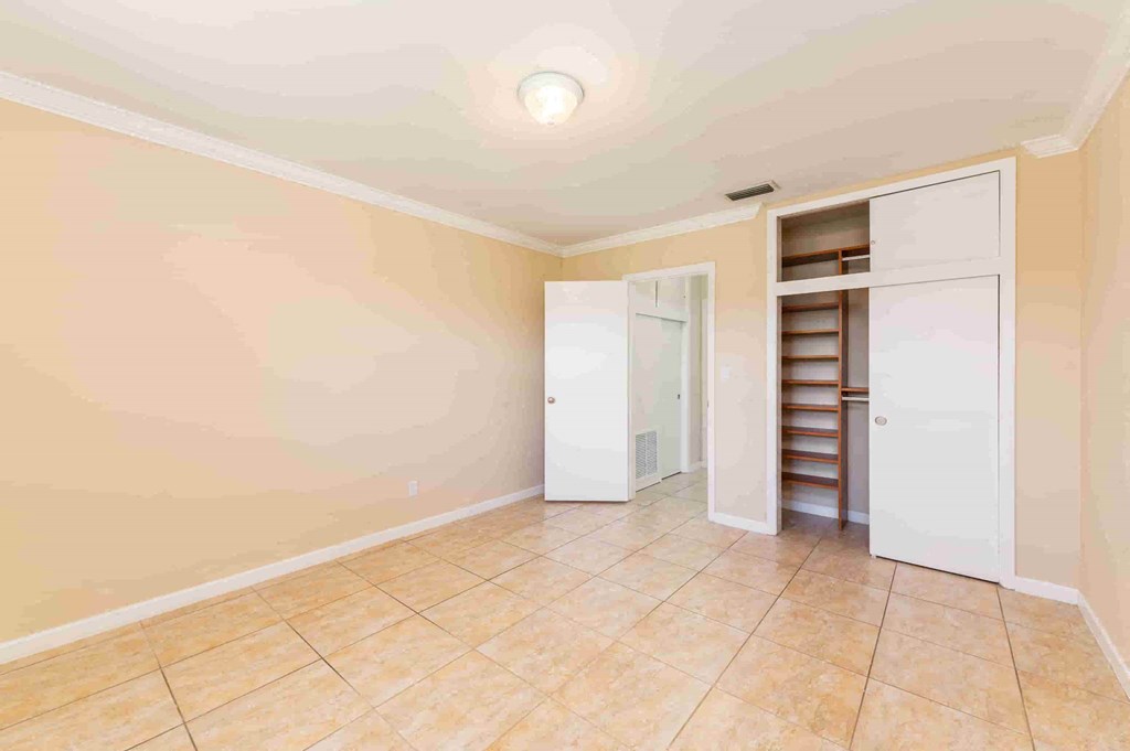 a room with a tile floor and a closet