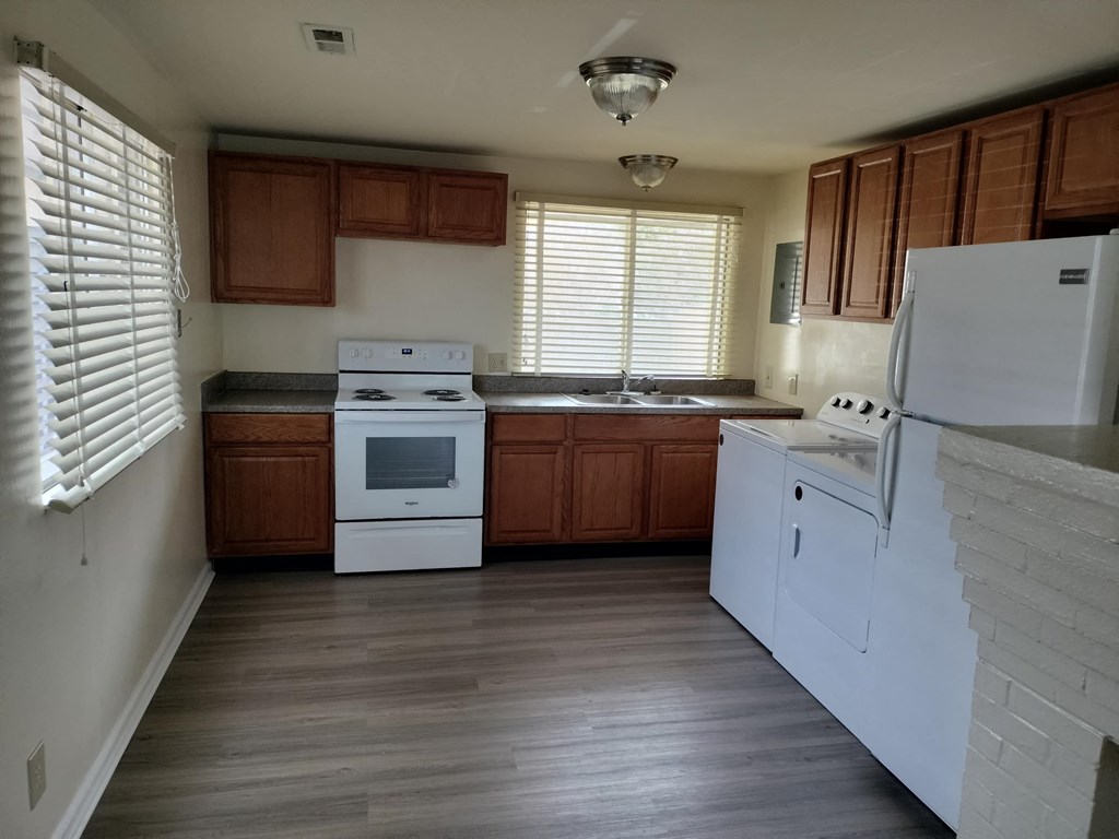 a kitchen with white appliances and wooden cabinets