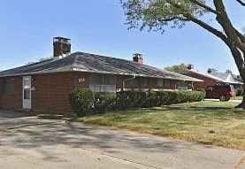 a house with a red car parked in front of it