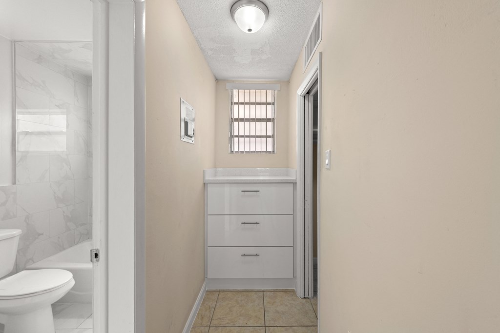 a bathroom with a sink and a toilet and a closet