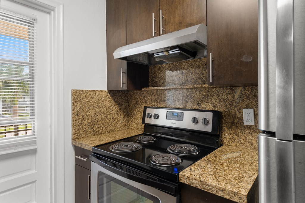 a kitchen with a stove and a refrigerator