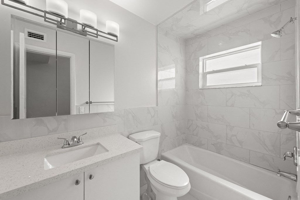 a bathroom with a sink toilet and a bath tub