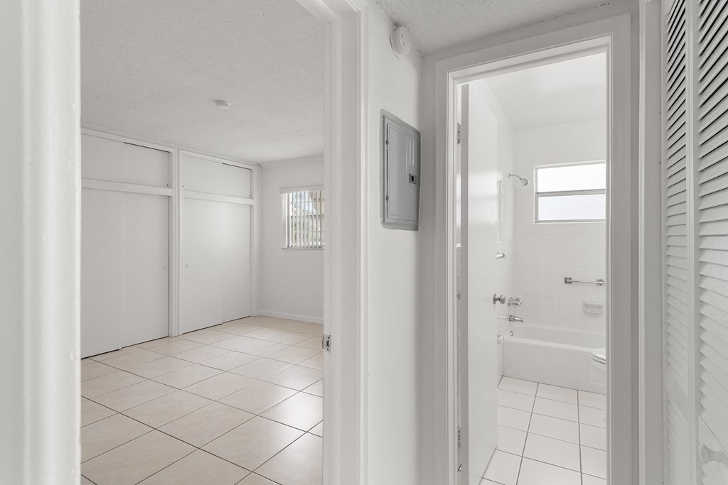 a view of a white bathroom from a door